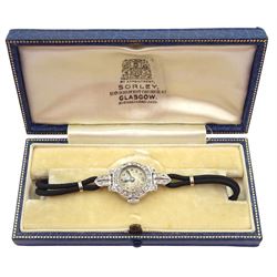 Art Deco platinum diamond set manual wind wristwatch, on black cord bracelet, with 9ct white gold clasp, cased