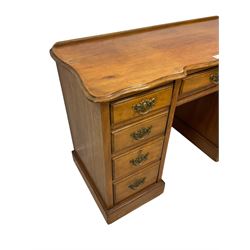 Late 19th century walnut twin pedestal desk, shaped moulded top over nine drawers, on moulded plinth base 