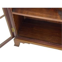 Early 20th century mahogany bookcase, projecting dentil cornice over blind fretwork frieze, enclosed by two astragal glazed doors, on shaped bracket feet 