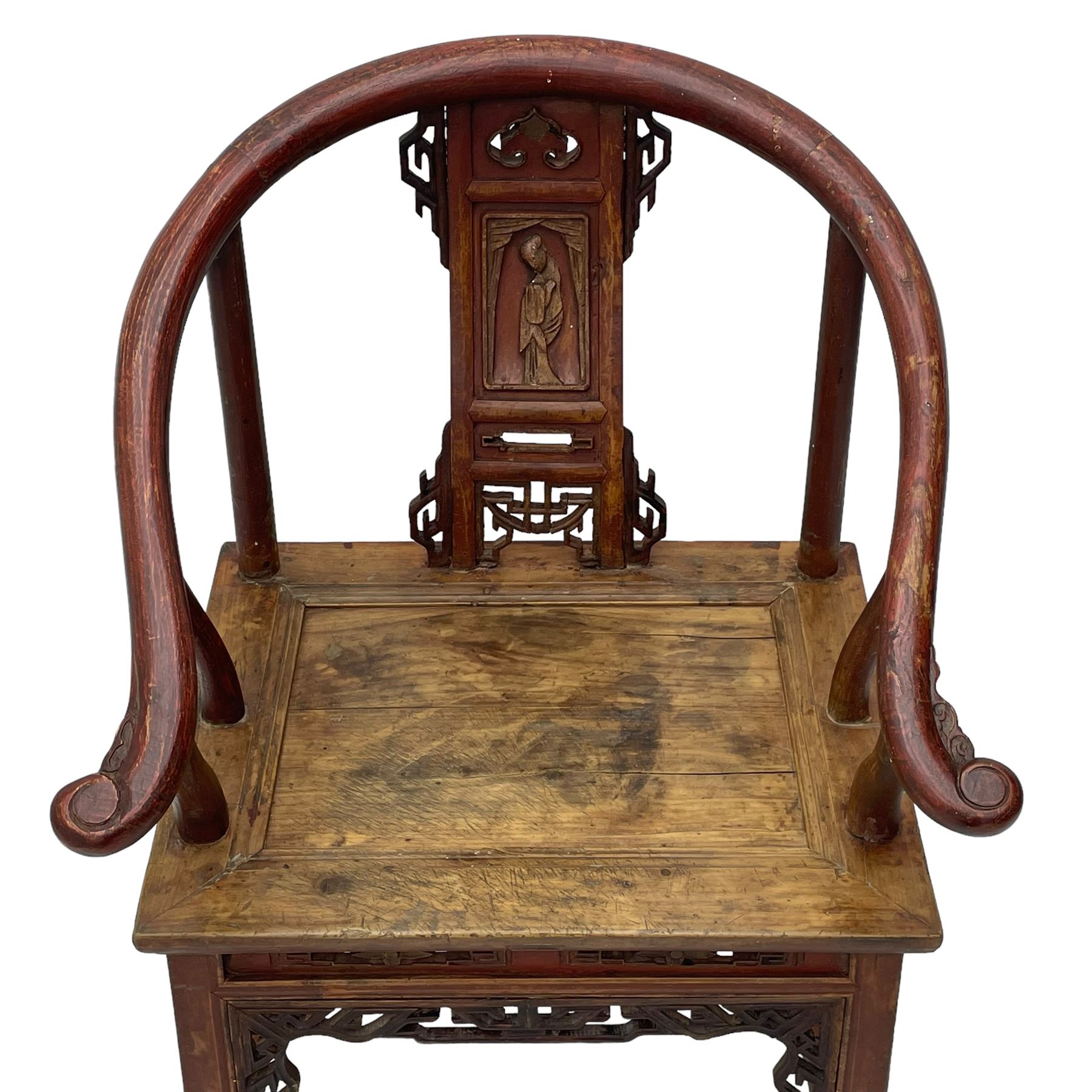 Late 19th century Chinese Qing dynasty horse shoe armchair, in elm, hung mu and Chinese softwood, horse shoe shaped upper rail carved with scroll terminals, shape back carved with solitary figure in robes, rectangular panelled seat in moulded frame, decorated with fretwork panels, on square supports united by stretchers 