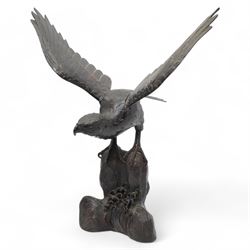 Japanese Meiji bronze eagle, raised upon a rock with crashing waves at the base, stood wit...