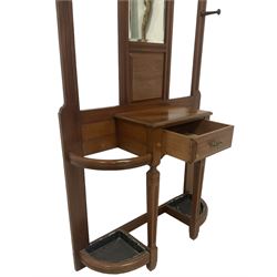 Late Victorian hallstand, raised pediment over balustrade frieze, bevelled mirror back with coat hooks over glove drawer, fitted with two drip-trays to base