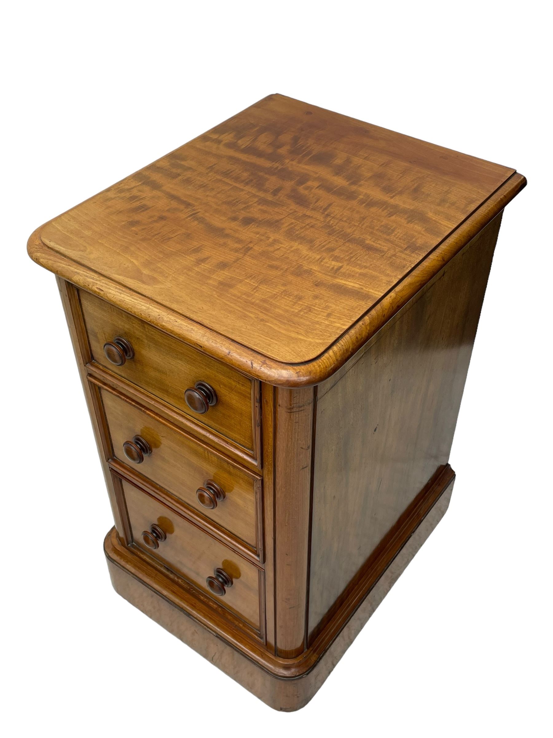 Pair of Victorian figured mahogany pedestal chests, rectangular form with rounded front corners, moulded top over three drawers with applied mouldings and turned handles, on moulded plinth base