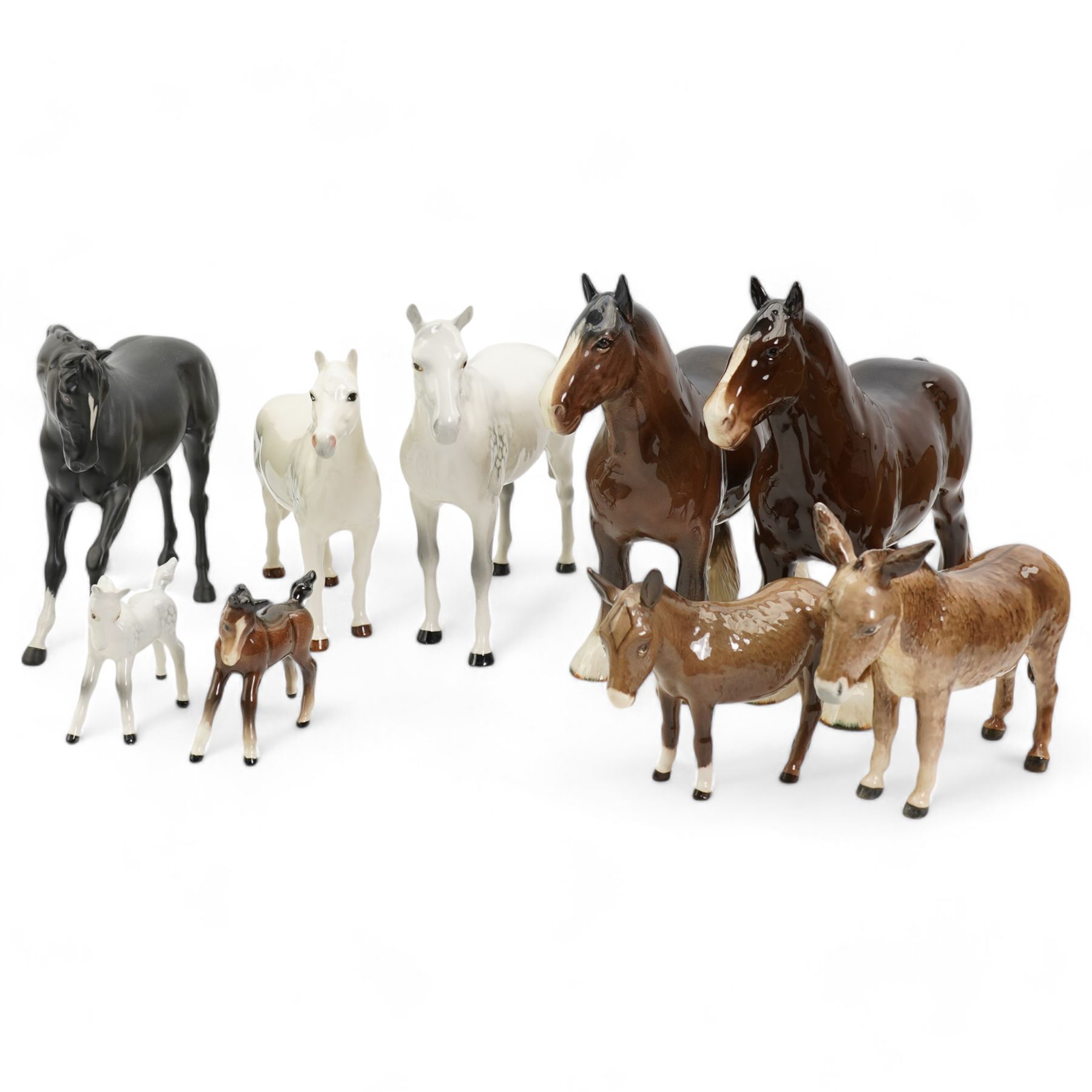 Group of Beswick horses and donkeys, including Connemara pony, a grey gloss stallion and foal, Black Beauty, another foal, two shire horses and two donkeys 