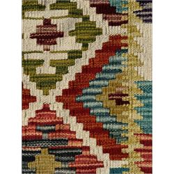 Chobi Kilim ground runner, the field decorated with a geometric pattern of coloured diamonds and triangles, each containing stylised motifs, the shorter ends enclosed by a plain border, and the longer sides with a multicoloured border

