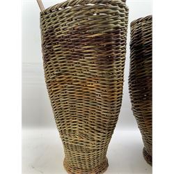 Two rattan baskets, of circular abstract form, together with two crook walking stick, basket H62cm 