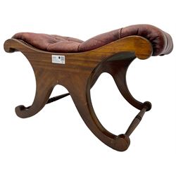 Late 20th century mahogany curved x-framed footstool, upholstered in buttoned red leather, splayed supports united by turned stretchers 