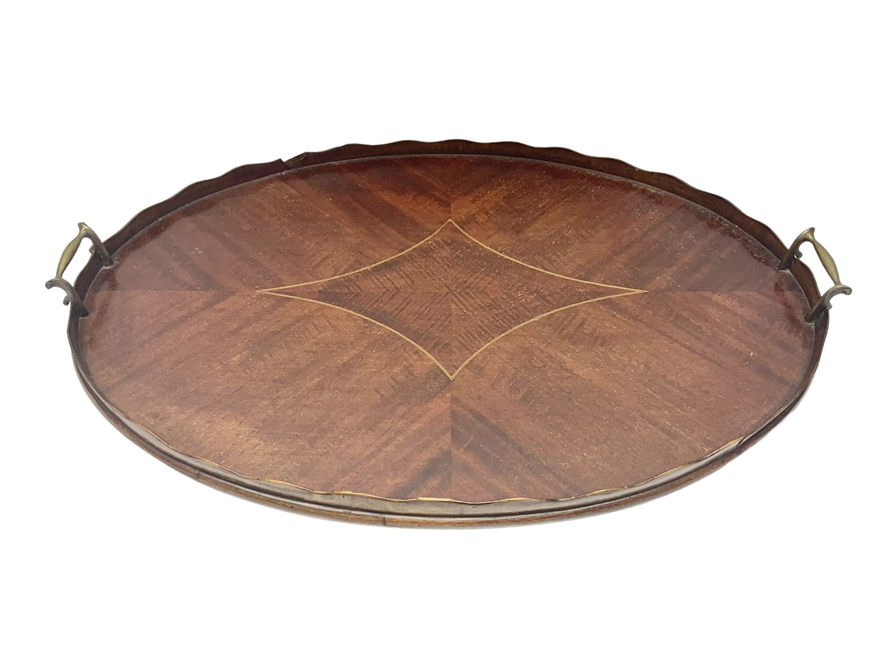 Early 20th century mahogany tray, of oval form with shaped rim and twin brass handles, with inlaid diamond decoration to centre, W67cm