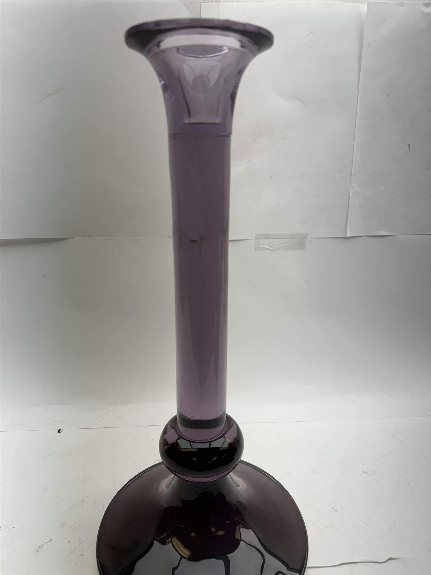 Large heavy gauge Scandinavian amethyst glass candlestick, the plain column with flared rim and basel knop, upon a spreading circular base, H44cm