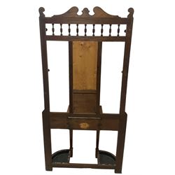 Late Victorian hallstand, raised pediment over balustrade frieze, bevelled mirror back with coat hooks over glove drawer, fitted with two drip-trays to base