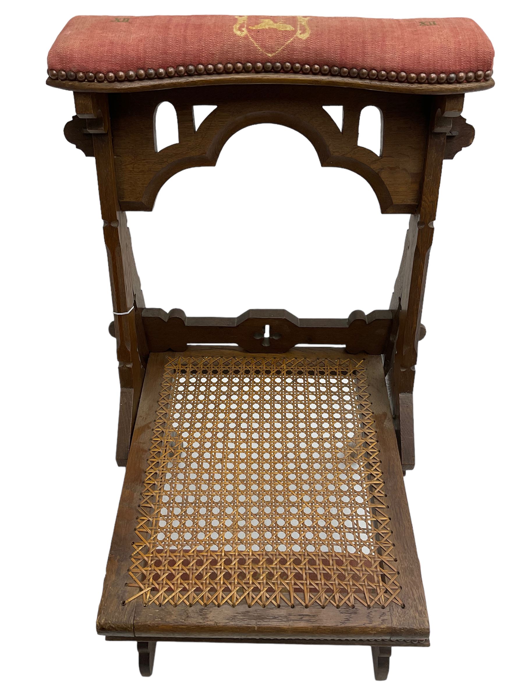 Late Victorian oak metamorphic prie-dieu chair, ecclesiastical design with pegged construction, upholstered kneel rest and top rest, hinged cane work seat