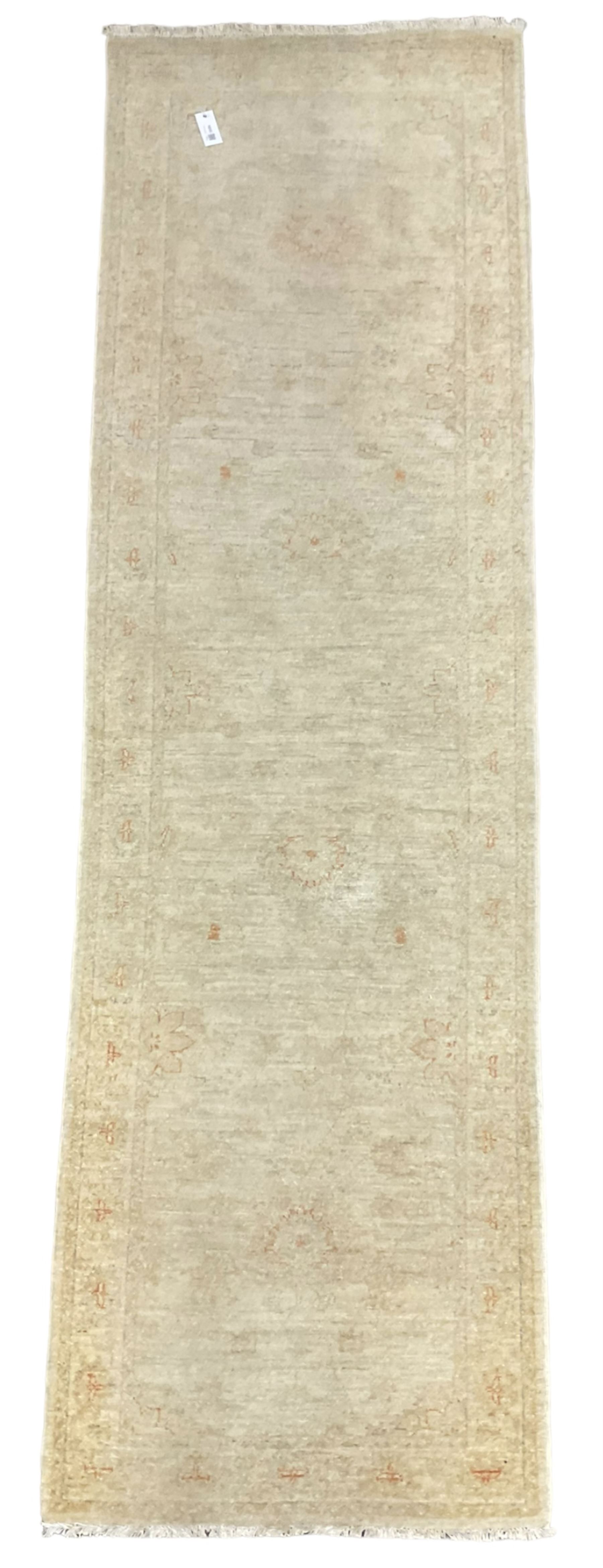 Persian Zeigler runner, ivory ground decorated with faint floral design 