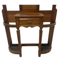 Late Victorian hallstand, raised pediment over balustrade frieze, bevelled mirror back with coat hooks over glove drawer, fitted with two drip-trays to base