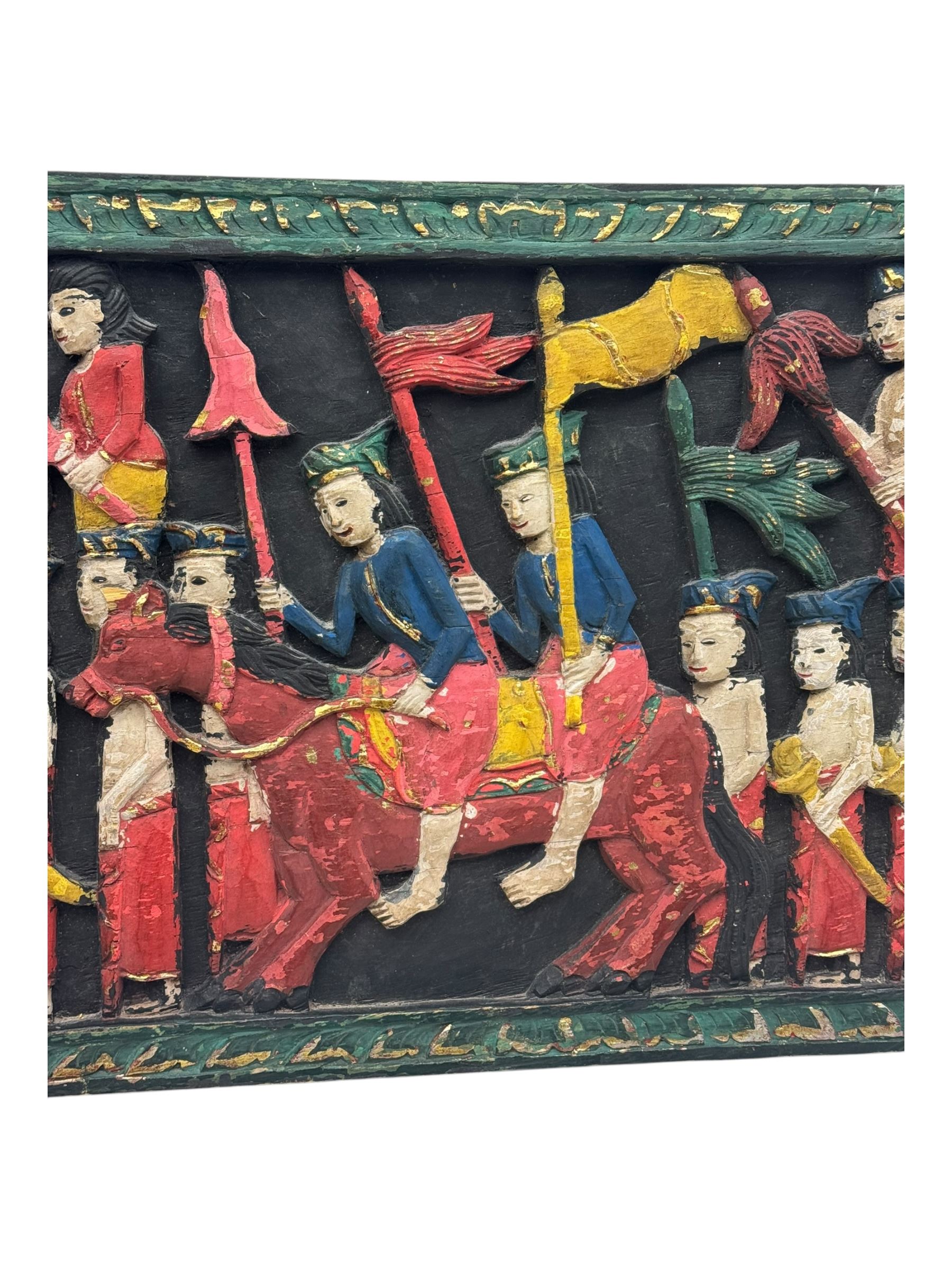 Rectangular relief carved and painted wall hanging panel, depicting ceremonial procession with soldiers and flag bearers on horses and elephants