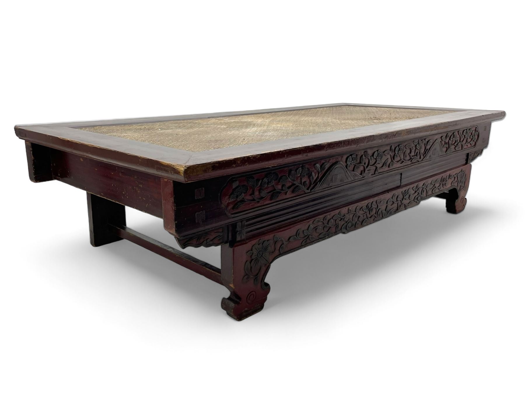 Mid-19th century Qing dynasty opium or wedding bed, Zhejiang province, rectangular top with weave cane work, the frieze rail carved with trailing leafy branches and flower heads, over moulded rail with small drawer, shaped base carved with further tailing foliate decoration terminating to shaped feet, united by stretchers 