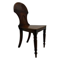 Regency mahogany hall chair, the carved back with shell motif and oval medallion, supported by turned front legs and splayed rear legs