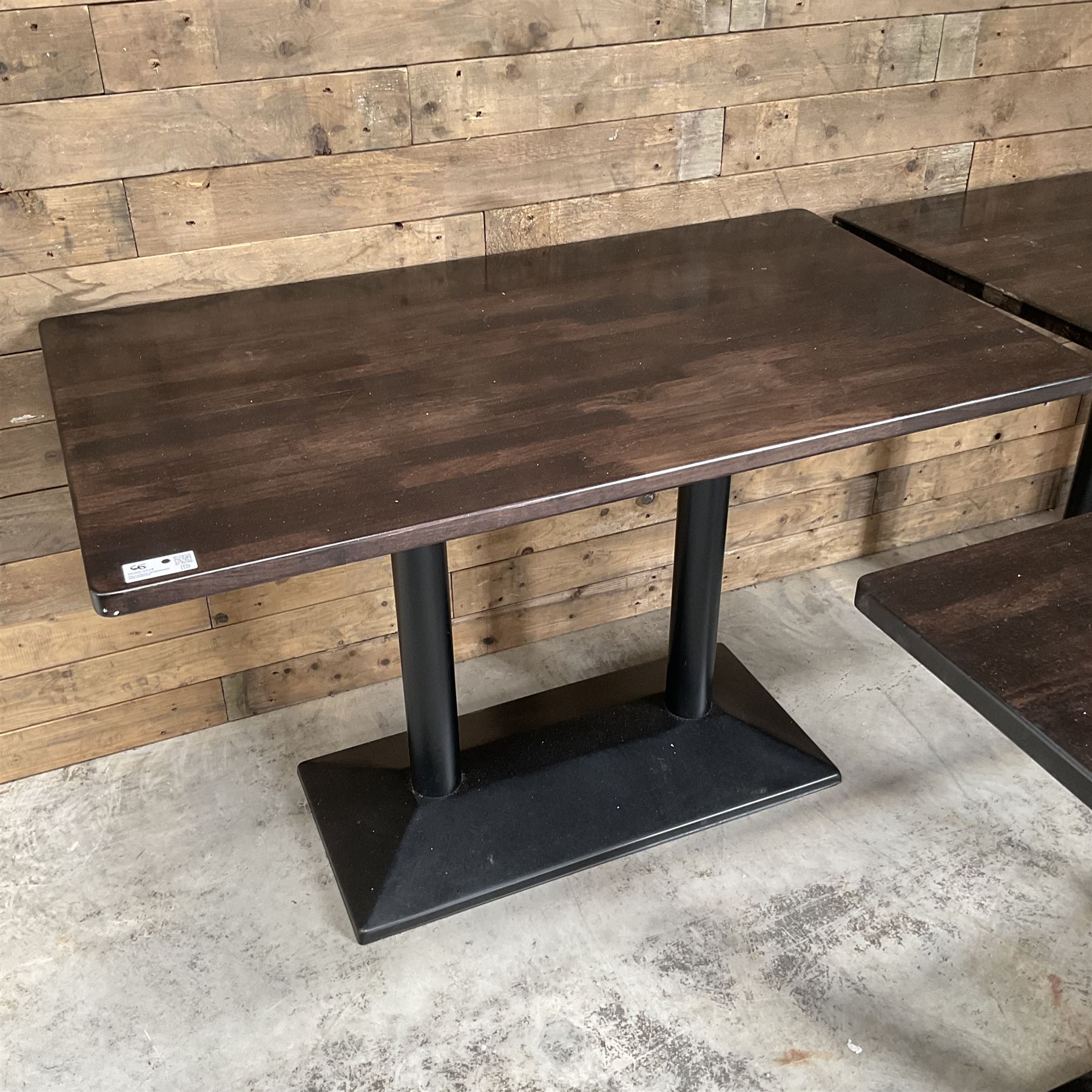 Three dark walnut rectangular console restaurant tables, on black metal bases