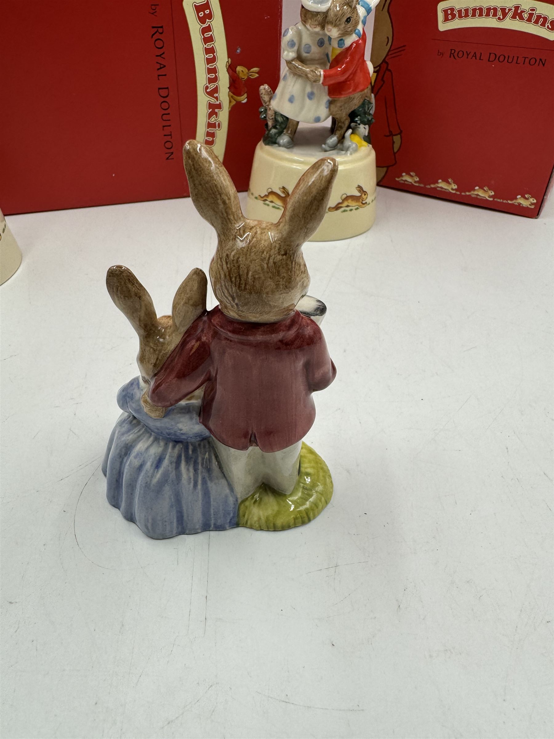 Two Royal Doulton Bunnykins music boxes, comprising Rocking Horse and Winter Waltz together with two Royal Doulton Bunnykins figures Once Upon a Time and Father, Mother & Victoria, all with original boxes  