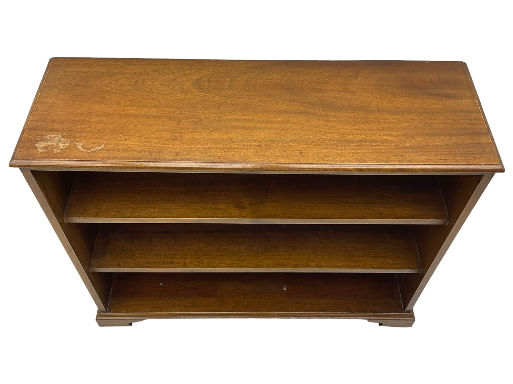 20th century mahogany open bookcase, fitted with two shelves, on bracket feet