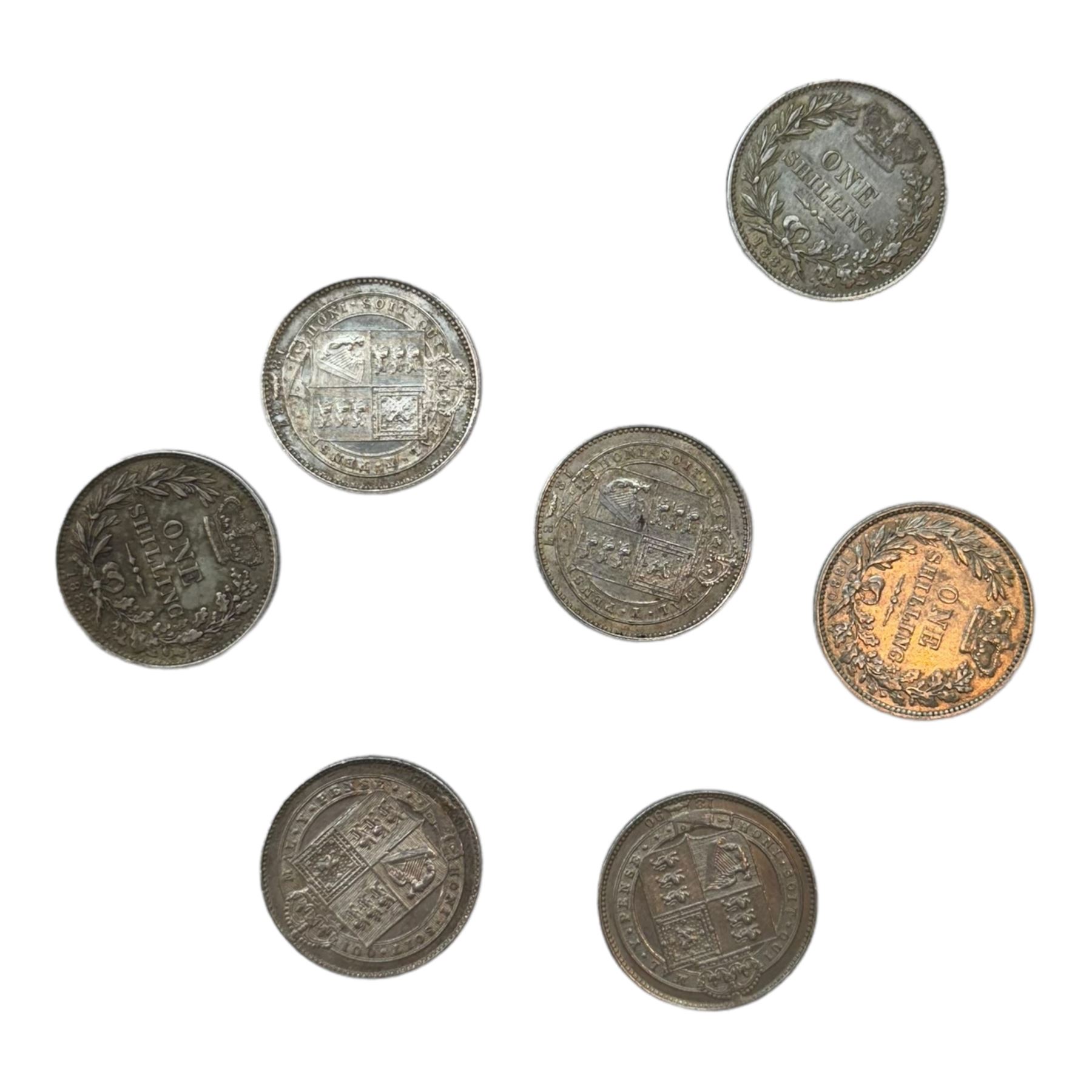 Seven Queen Victoria silver one shilling coins, dated 1880, 1883, 1884, two 1887, 1890 and 1892