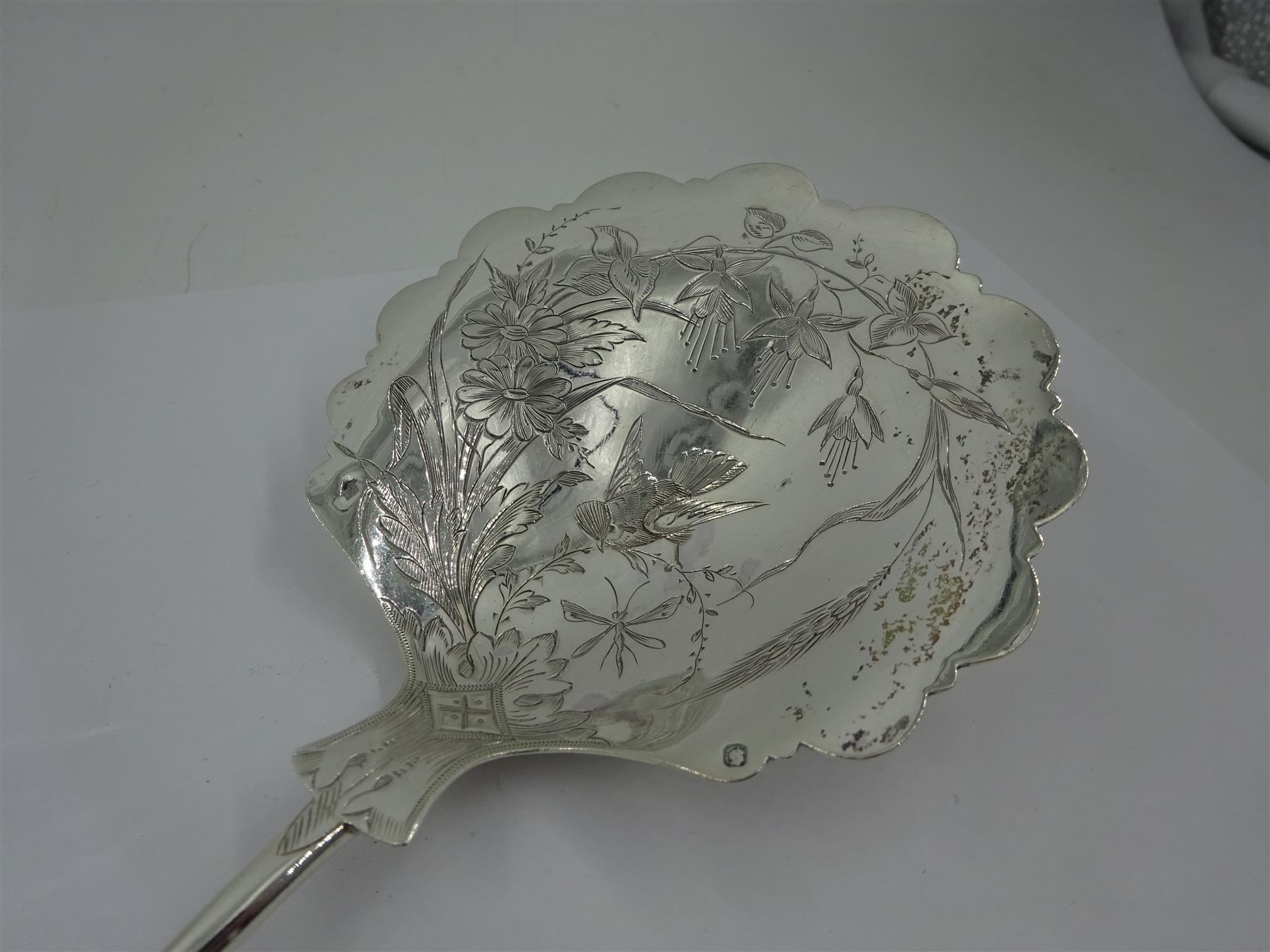 French silver aesthetic movement serving spoon, the scallop edged bowl engraved with a bird amongst flowers and foliage, stamped with Minerva's head standard and weevil export mark, L23cm