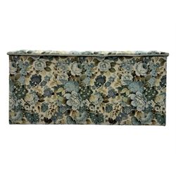 Mid 20th century oak blanket box, upholstered in floral pattern fabric, padded hinged lid enclosing oak interior with two removable trays, brass side handles, on round metal supports