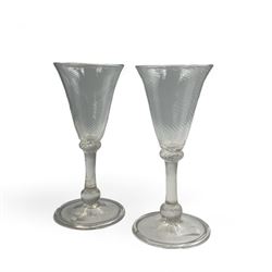 Pair of 18th century Liege wine glasses, circa 1730, with wrythen fluted trumpet bowls and knopped stems, H14.5cm