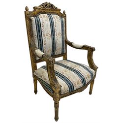 Late 20th century French design carved giltwood armchair, the cresting rail carved with scrolled foliage over foliate carved platform, upholstered in striped fabric decorated with trailing foliage and flower heads, acanthus carved arm terminals and upright supports, on turned and fluted supports 