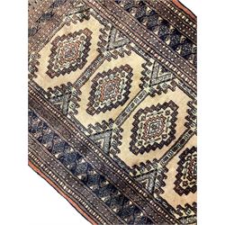 Persian peach ground rug, the field divided into four panels each with geometric lozenge, multiple band border with stylised flower head motifs, the end panels decorated with repeating lozenges