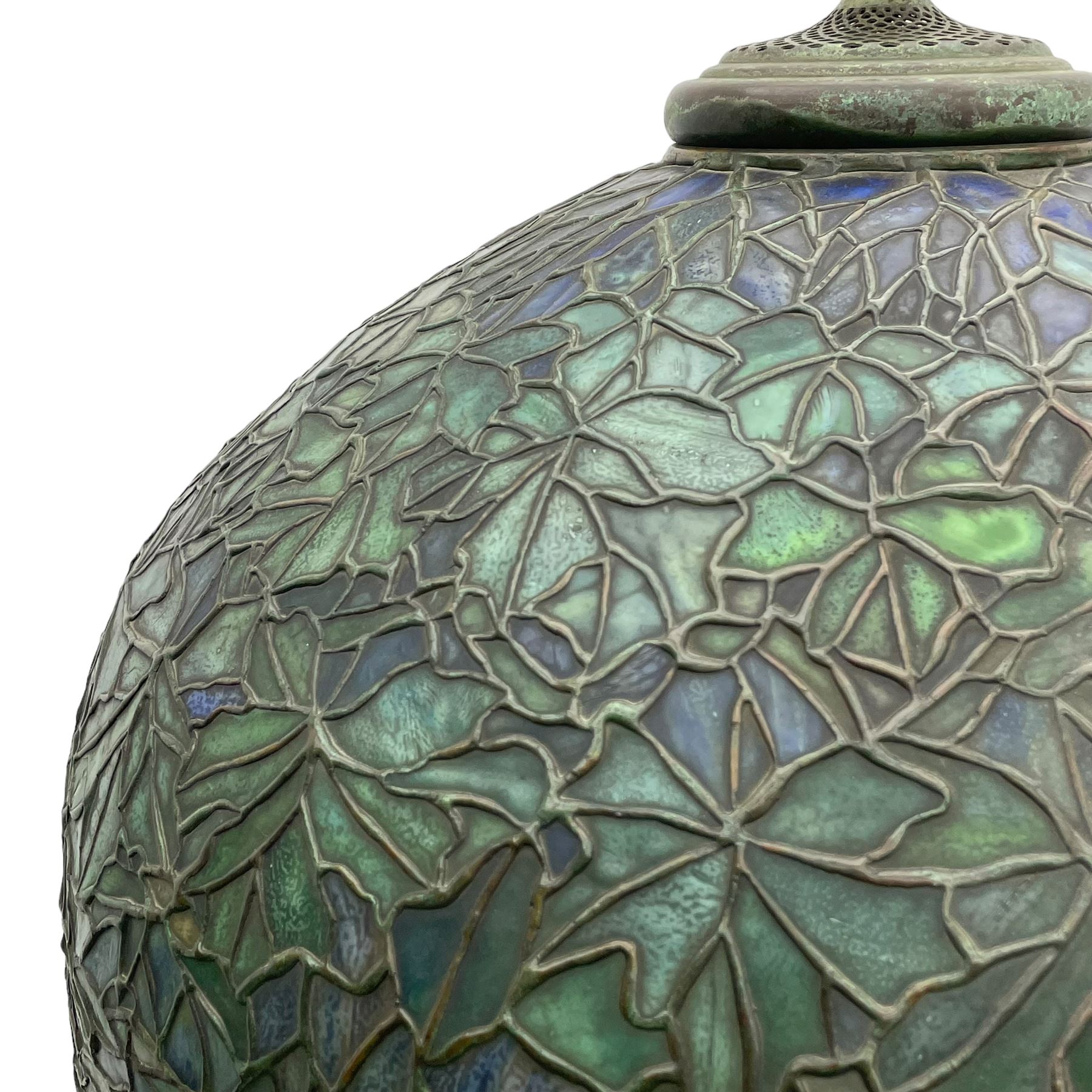 In the manner of Tiffany & Co. - bronze 'Chased Pod' design floor lamp, 'Maple Leaf' dome leaded glass shade decorated with flowers in blue and green shades, six branches on column decorated with stylised trailing stems terminating to circular base with stylised plant decoration, on scrolled feet, the base stamped 'Tiffany Studios New York 379' the inner shade stamped 'Tiffany Studios New York [...]'