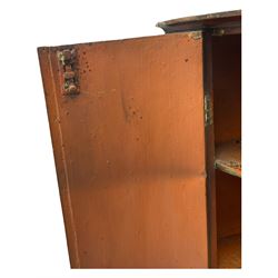 George III mahogany bow-front corner cupboard, enclosed by two figured doors with brass hinges and escutcheon, the painted interior fitted with three shelves 