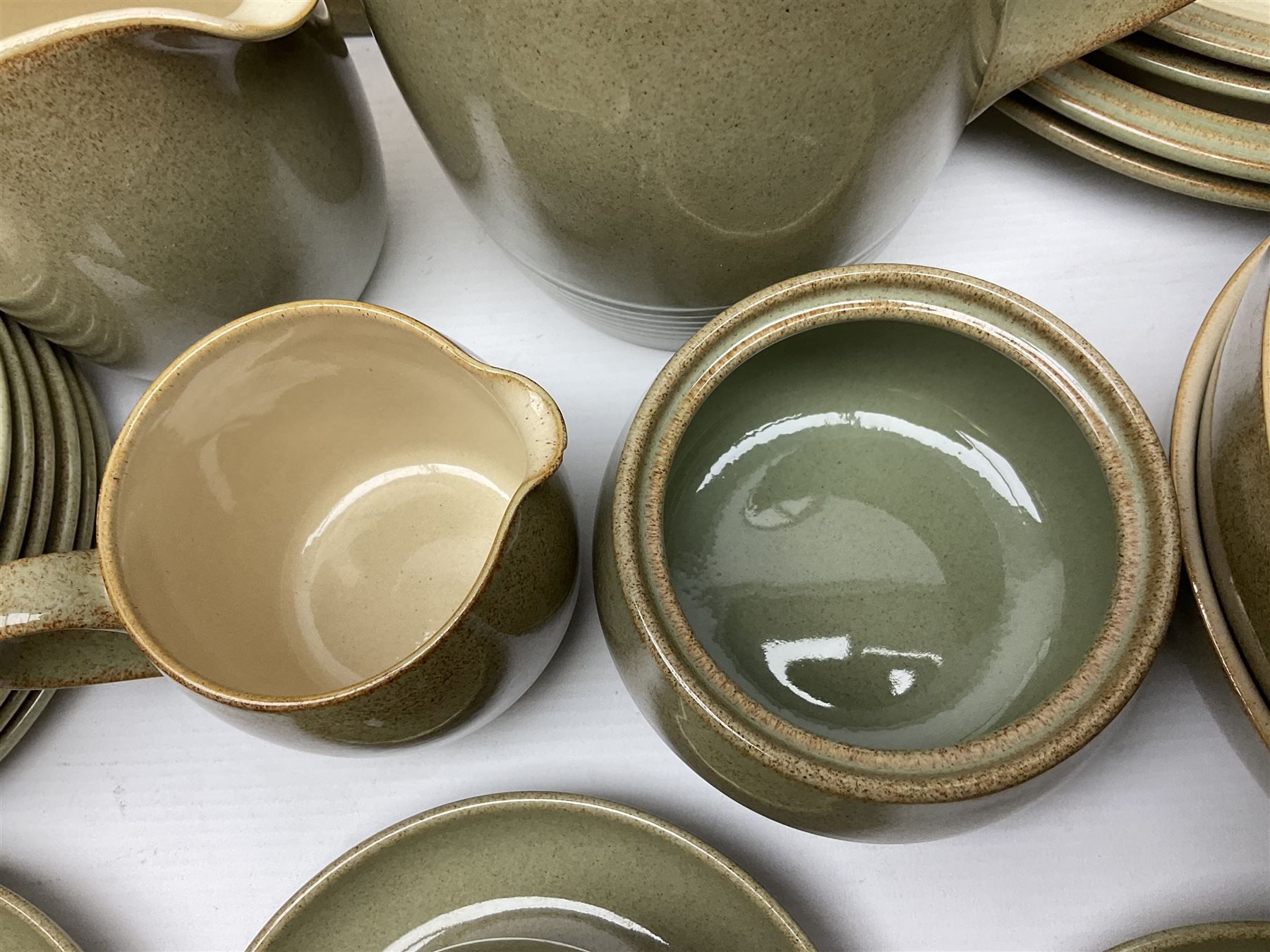 Denby tea and dinner wares, including bowls, jugs, tureens, side plates, dinner plates, serving dishes, cups and saucers, coffee pot, etc, all decorated with a green and brown mottled glaze, with printed marks beneath, in two boxes 