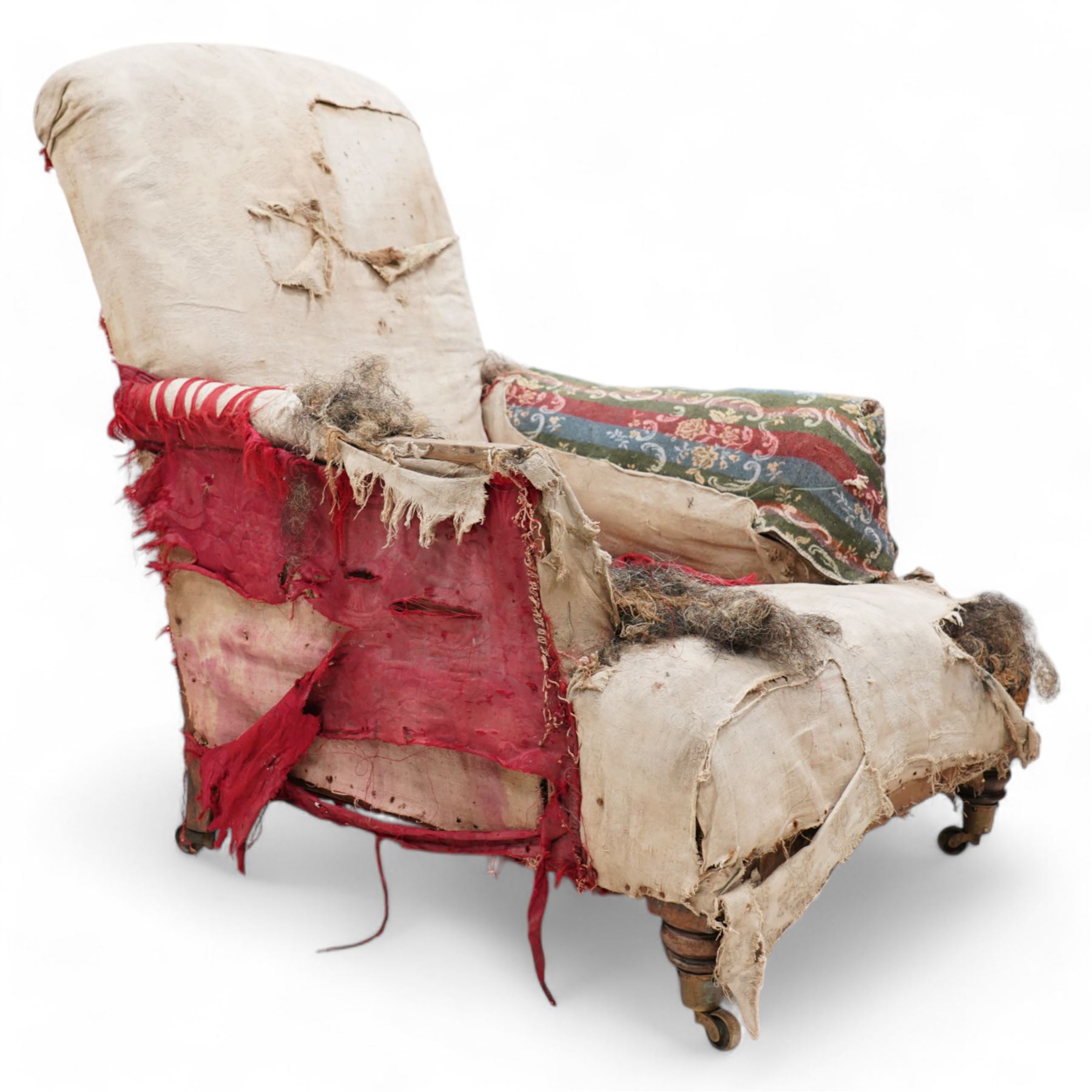 19th century rosewood and beech framed armchair, traditional shape with arched back over deep seat, on turned front feet with brass castors 