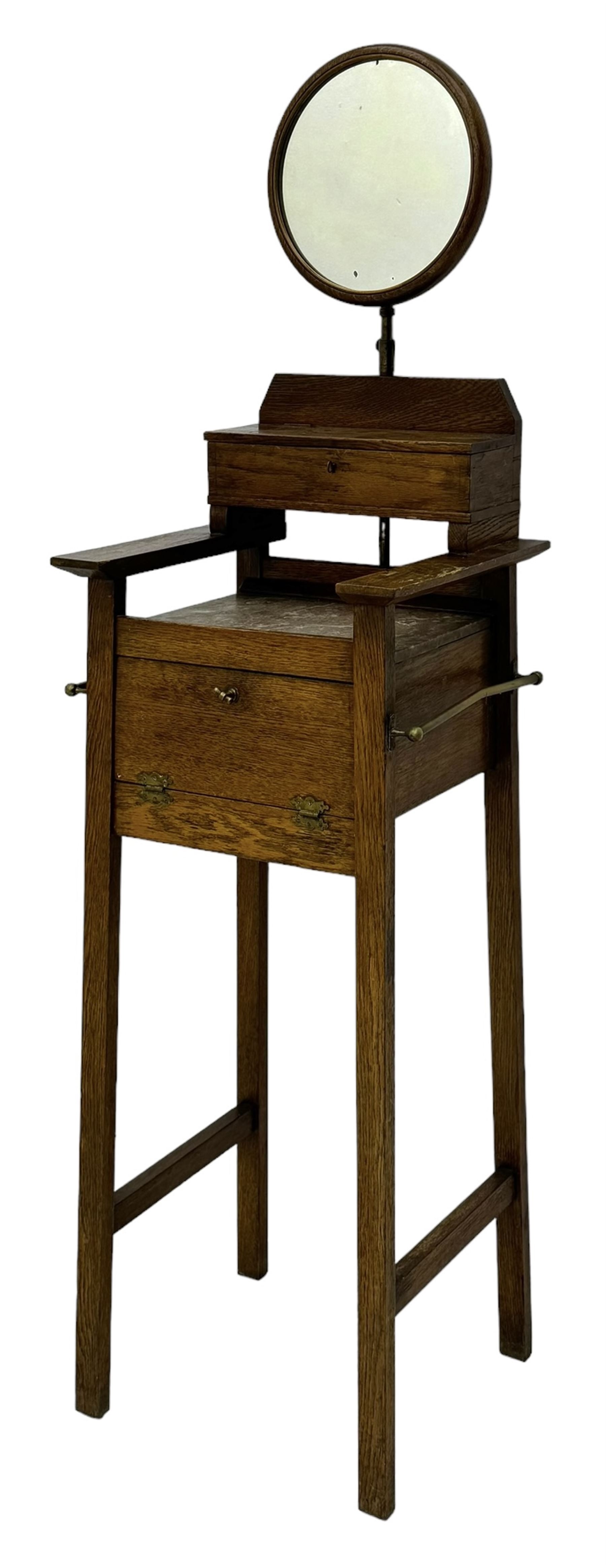 Early 20th century oak vanity stand, with circular adjustable mirror, brass towel rails to the sides, marble inset top and upper compartment, over additional storage compartment with hinged front, on splayed supports with stretchers