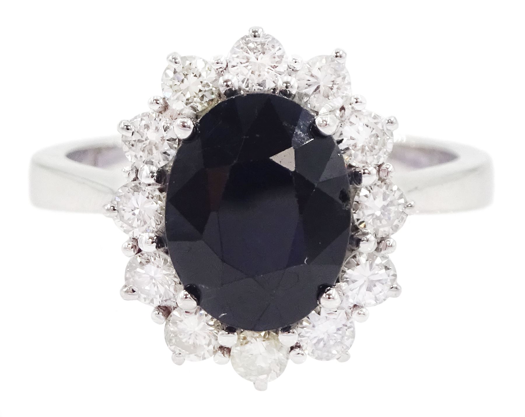 18ct white gold oval cut sapphire and round brilliant cut diamond cluster ring, hallmarked, sapphire approx 2.60 carat, total diamond weight approx 0.55 carat