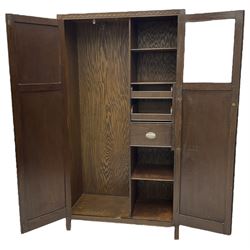 Mid-20th century oak wardrobe, enclosed by two panelled doors with carved mounts, the interior fitted with drawers and shelves 