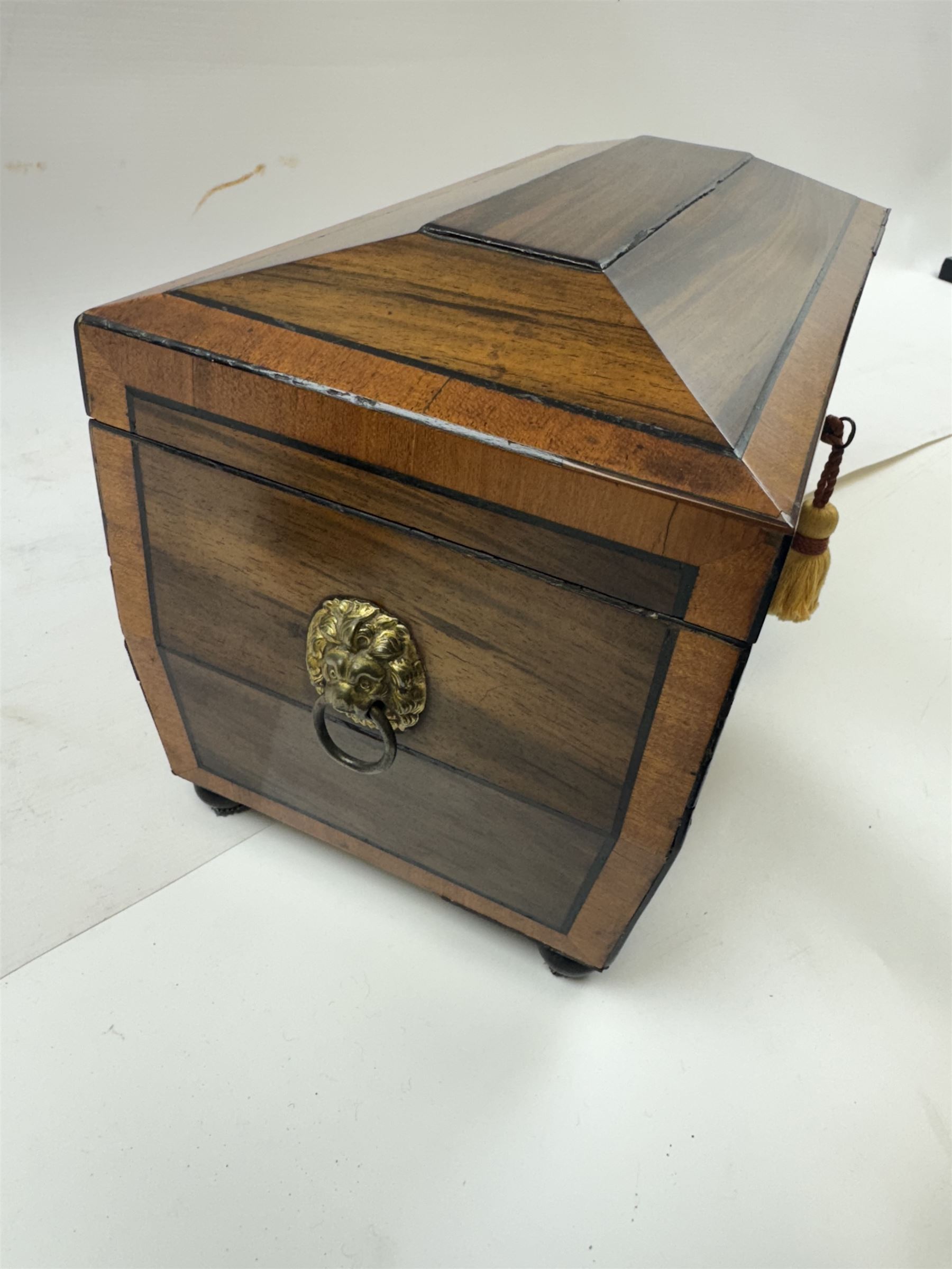 Georgian sarcophogus shaped tea caddy, with inlaid panels and twin lion mask handles, with mahogany compartmentalised interior, upon four bun feet, H22cm