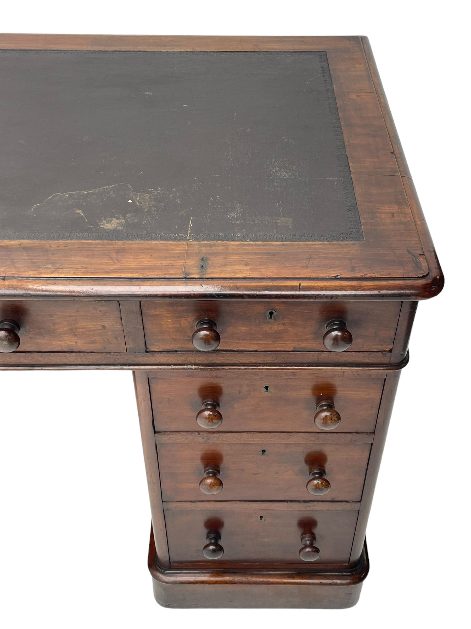 Victorian mahogany twin pedestal desk, moulded rectangular top with inset leather writing surface, nine drawers each fitted with two turned handles, on moulded plinth base 