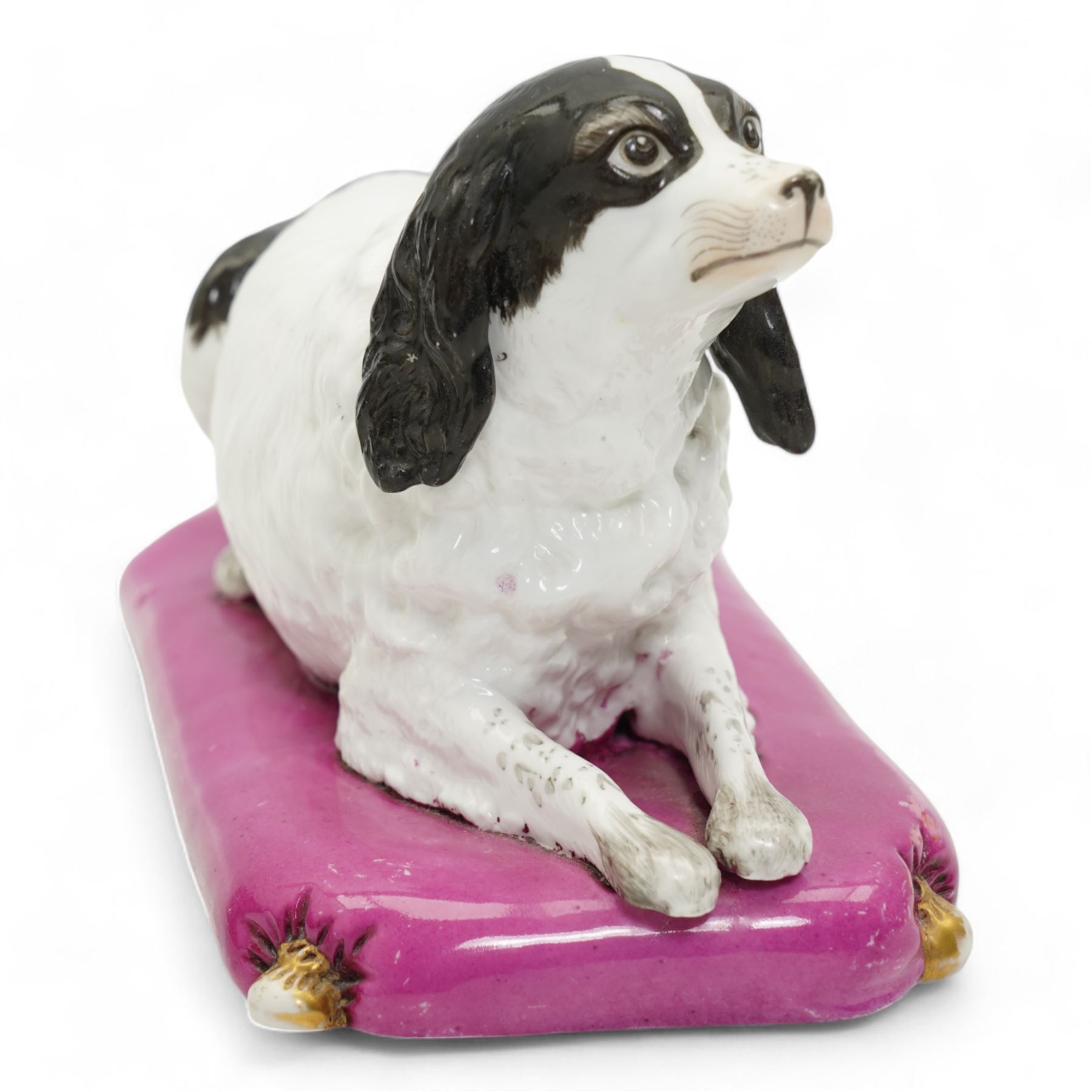 Mid 19th century Copeland & Garrett model of a recumbent spaniel upon a pink tasselled cushion, printed marks beneath, L20cm x H12cm