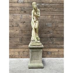 Cast stone garden figure of a bathing lady, raised on square plinth