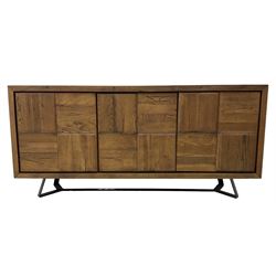 Samba 'Camden' oak sideboard, rectangular top over three block panelled cupboard doors, raised on angled black metal supports connected with stretcher