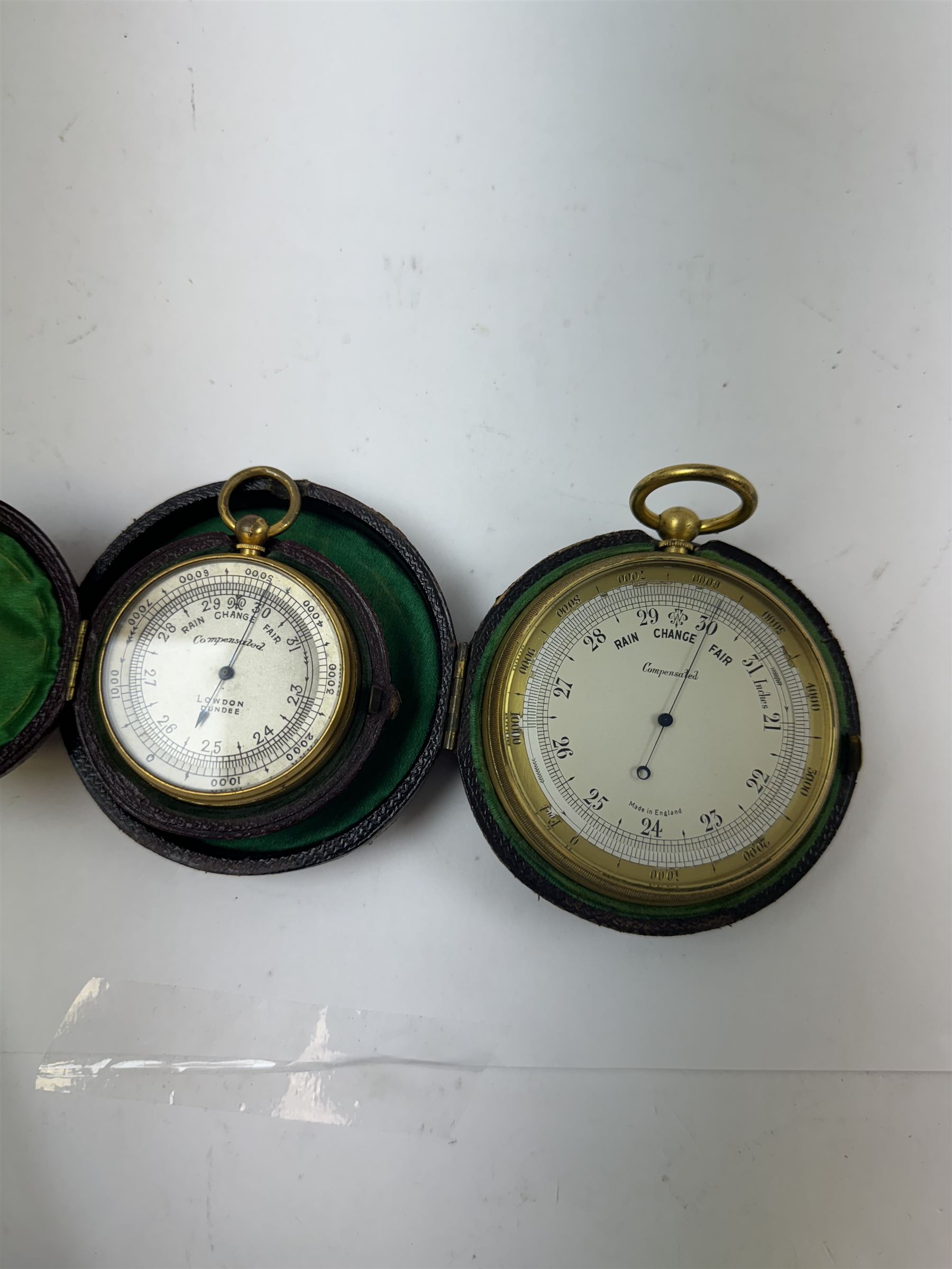 Lowdon Dundee, an early 20th century leather cased pocket barometer with silver dial, D4cm, together with another larger and later example, both cased