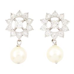 Pair of platinum and white gold pearl and old cut diamond stud earrings, eleven old cut di...