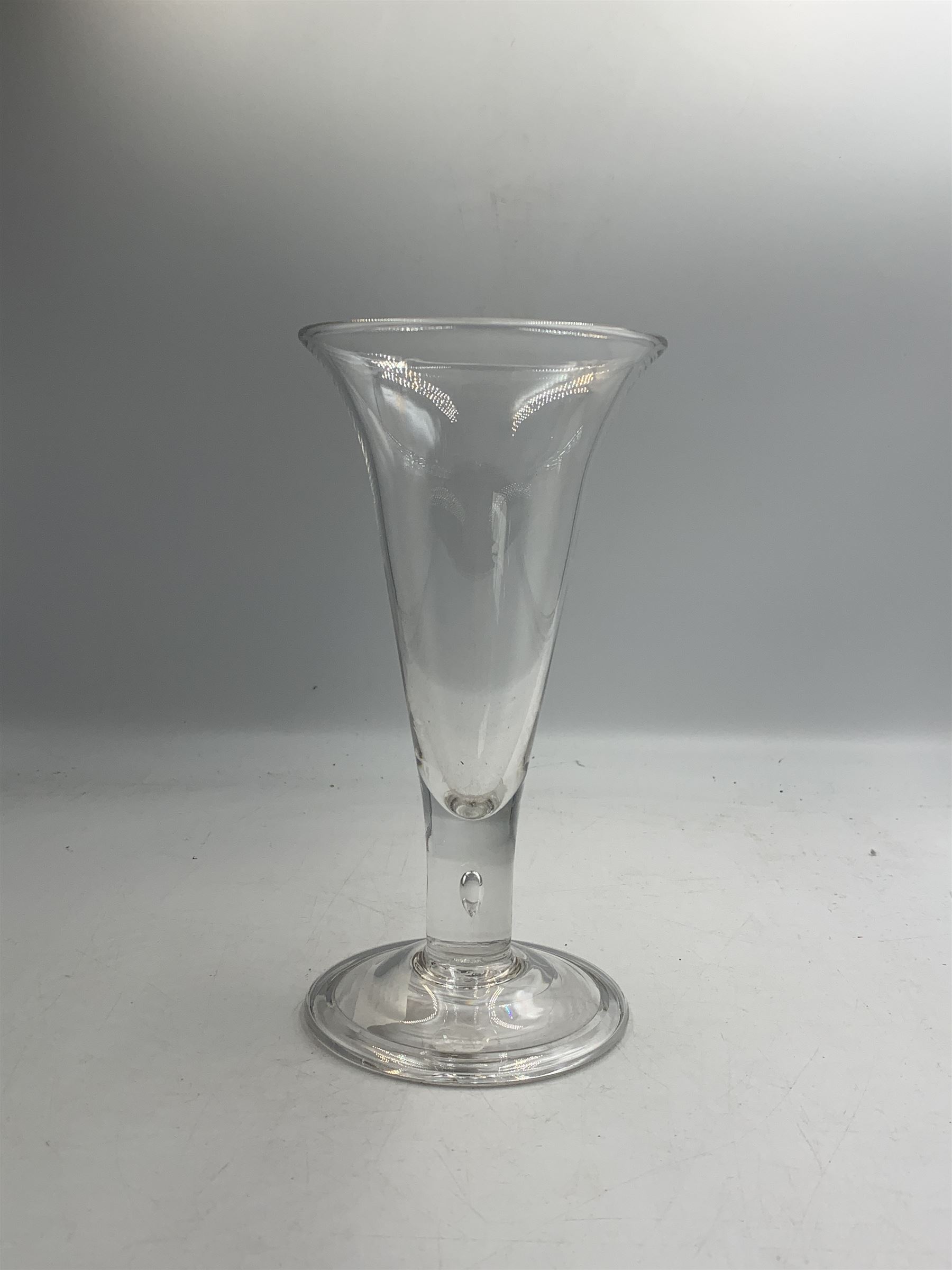 Large 18th century ale glass, circa 1780, with drawn trumpet bowl and flared rim, teardrop stem on a domed folded foot, H20cm