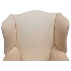 Georgian design mahogany framed wingback armchair, high shaped back over rolled arms with sprung back and seat, on compressed bun feet, upholstered in calico