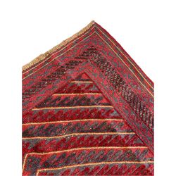 Meshwani indigo and maroon ground rug, the field decorated with a central lozenge with concentric borders containing hook motifs, enclosed by geometric zig-zag guard lines