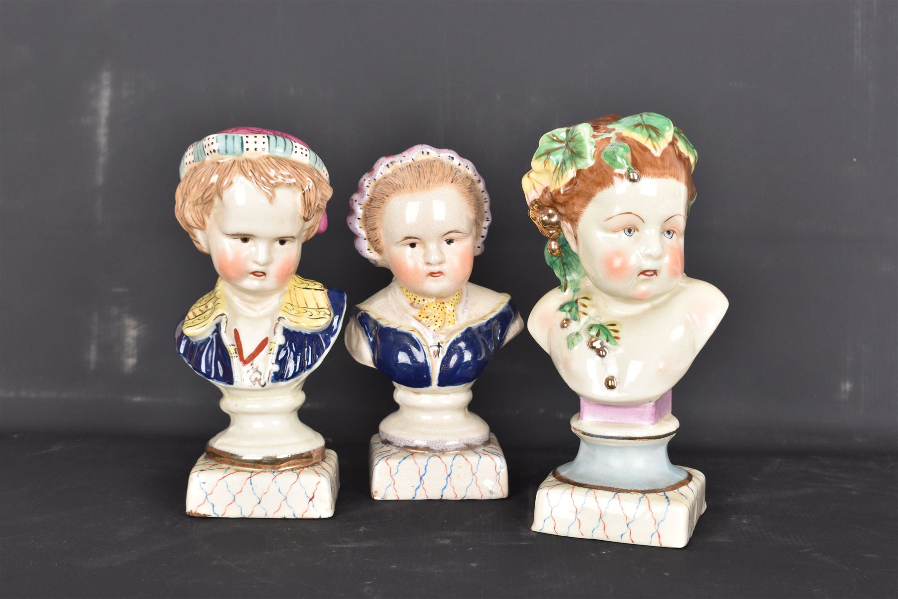 Pair or 20th century continental Bourbon children busts, together with another similar, H23cm