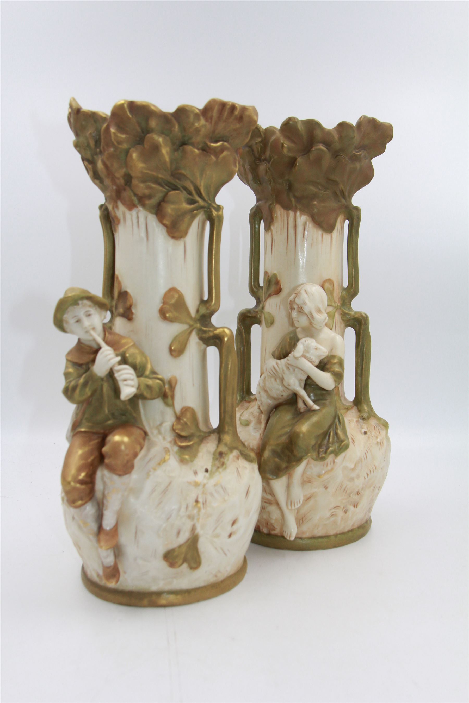 Pair of Royal Dux twin handled vases, no. 1966 & 1967, one depicting a shepherd and the other a shepherdess, each upon a naturalistically textured green, cream and gilt ground, both with pink triangle mark beneath, H31cm