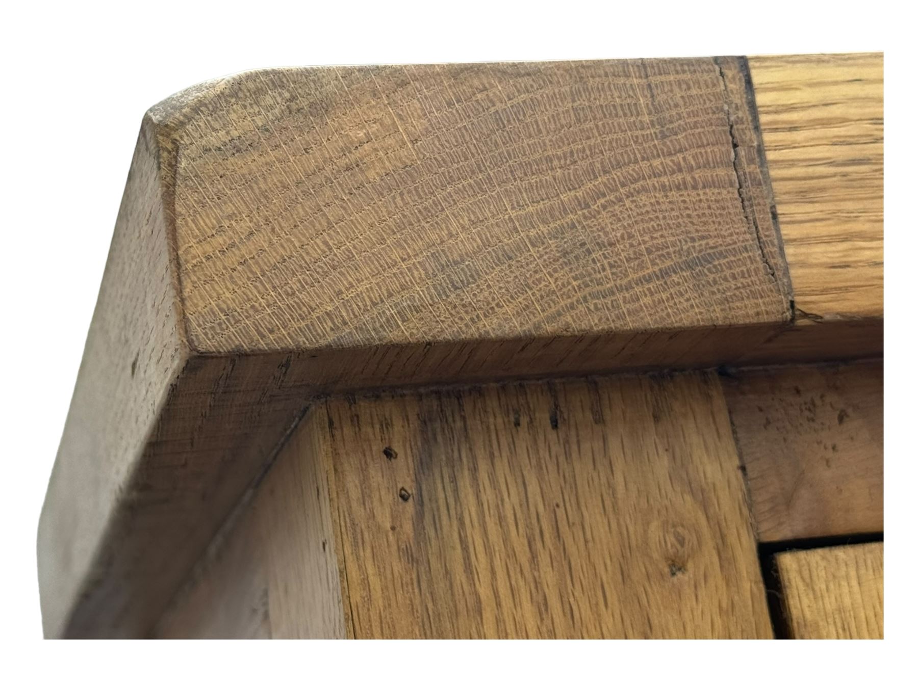 Oak dresser, upper section with twin glazed cupboard doors and central shelving with two trinket drawers, lower section fitted with six drawers over three panelled cupboard doors, raised on shaped feet 