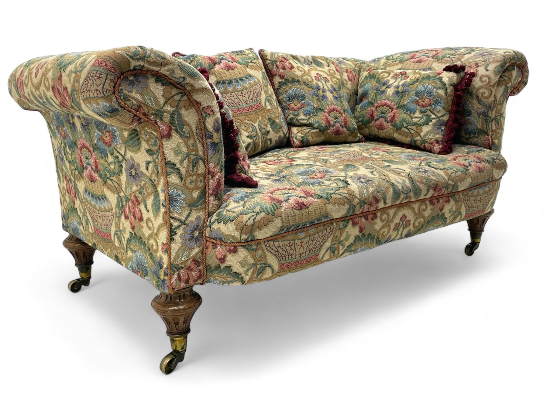 Mid-19th century walnut framed two-seat sofa, rolled arms over sprung seat, single drop-end action, raised on turned and fluted feet with brass cups and castors, upholstered by E & S Gott in traditional floral pattern fabric decorated with urns